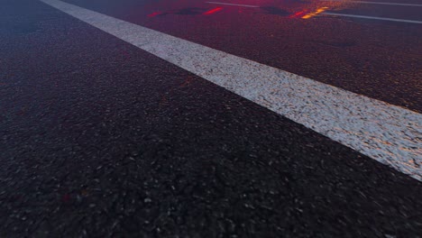 3d heavy rain hitting road at night - 4k realistic rain particle (loopable) - rainy day on a colorful street with traffic - wet road at night - low angle shot of in the rain - rainfall and reflection on road - loopable moving image - long exposure