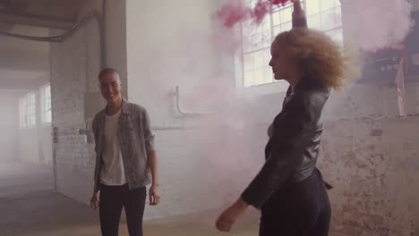 fashionable young man and woman in an abandoned warehouse