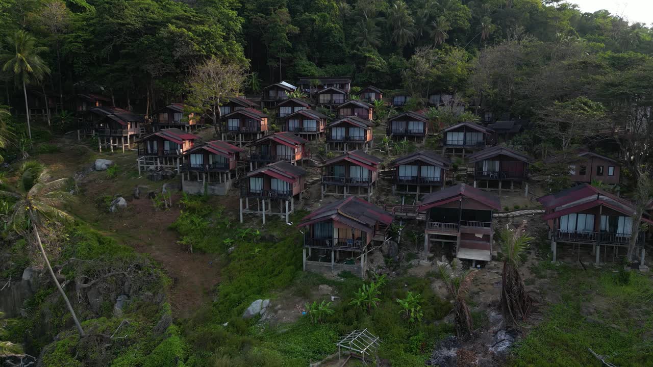 Aerial view of traditional housing complex in Long beach , a tropical malaysian island, showcasing lush greenery. Rocky coastline. And crystal clear turquoise waters