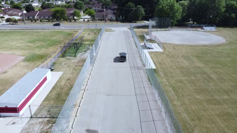 a mavic mini tracks a new truck from a parking lot down a side street.