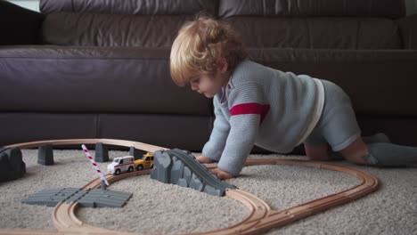 Little-boy-playing-with-toy-track