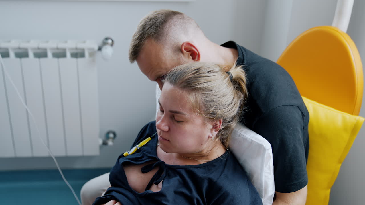 Husband is holding his pregnant wife in arms. Woman feeling pain from the contractions. Close up.