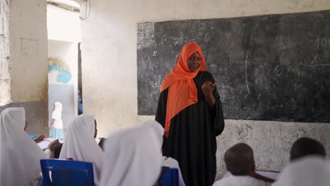 muslim islamic african teacher talking to the children at school