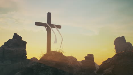 wooden cross on mountaintop at sunrise/sunset