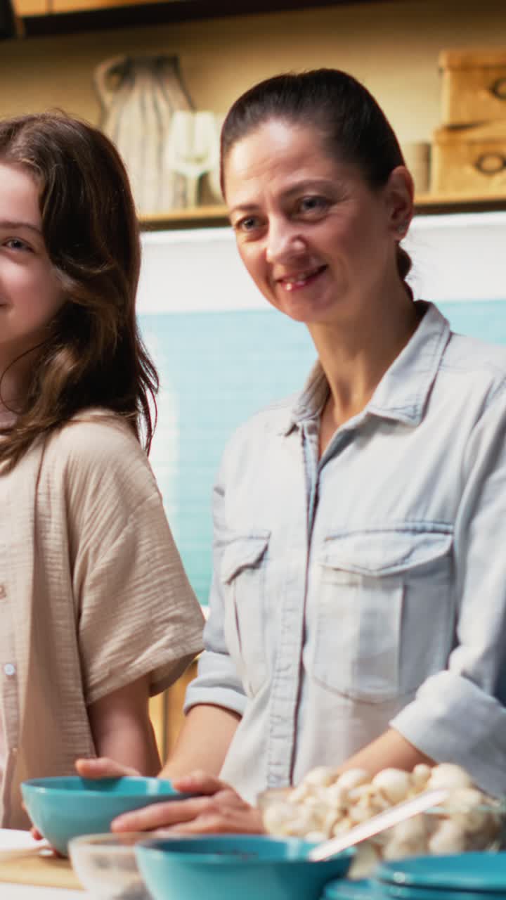 Vertical Video Cute little family laughing and preparing homemade pizza in the kitchen