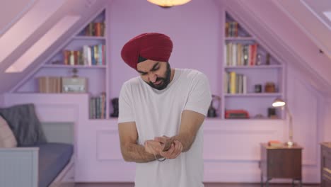 sick sikh indian man suffering from hand pain