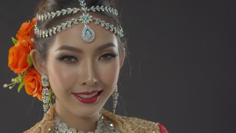 portrait of an indian bride with traditional makeup and jewelry on her wedding day - close up static poses