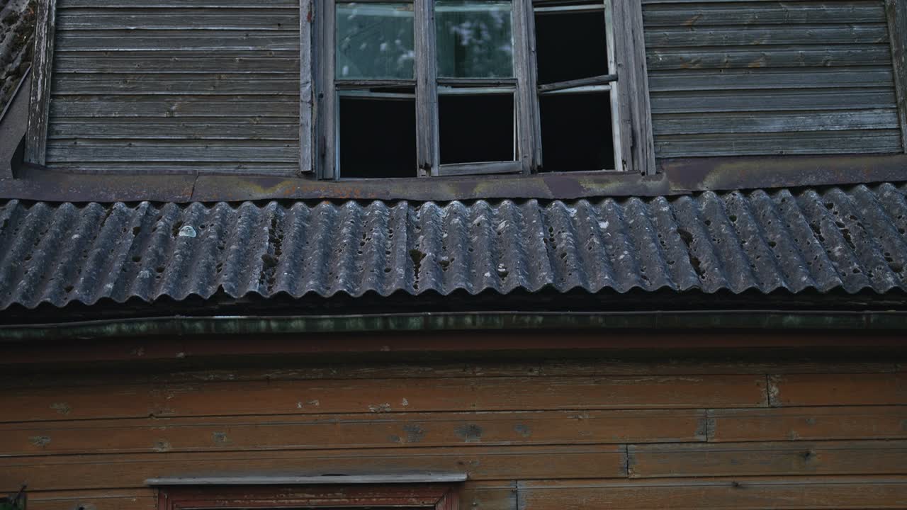 Old abandoned house with boarded up windows.