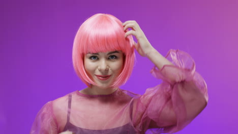 Portrait-Shot-Of-A-Beautiful-Woman-Wearing-A-Pink-Wig-Posing-And-Smiling