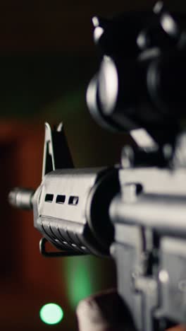 vertical video shooting gallery client hitting targets, extreme close up of rifle