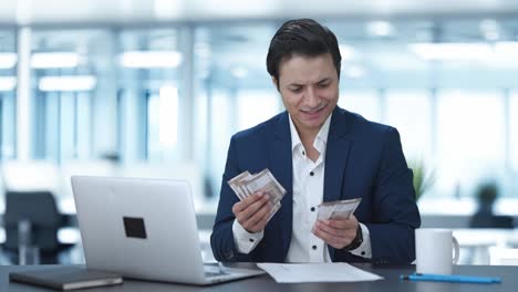 hombre de negocios indio feliz contando dinero