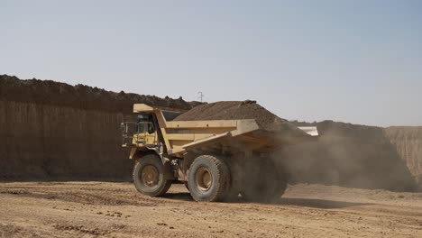 a large truck loaded with sand is heading towards the construction site, aerial shots of the truck alongside the construction site and materials