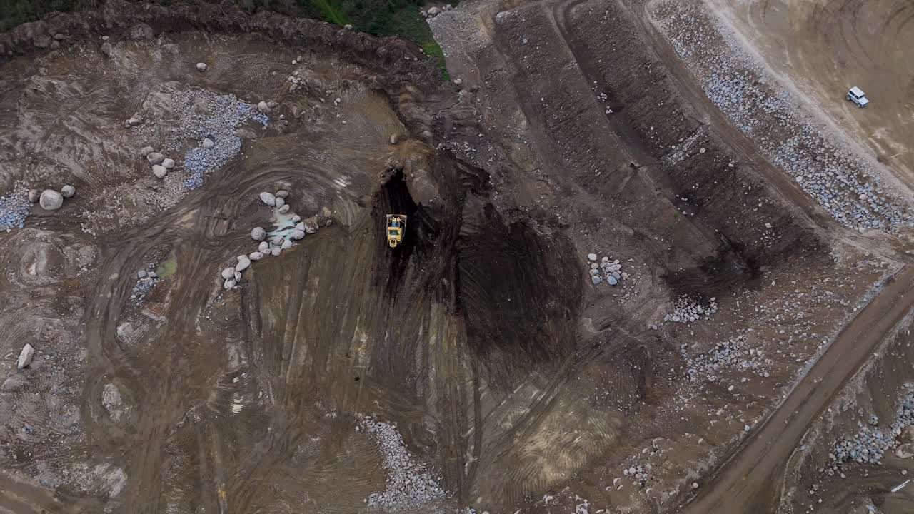 Aerial - single excavator working in rocky quarry Revinhade Felgueiras Portugal