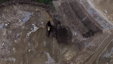 aerial - single excavator working in rocky quarry revinhade felgueiras portugal