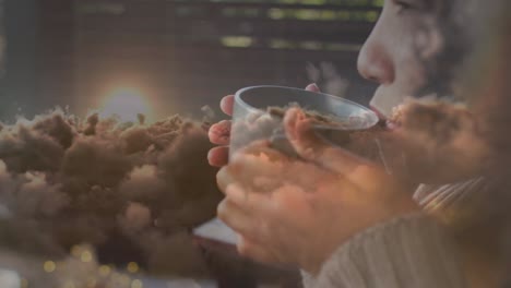 animation of biracial woman drinking tea over clouds