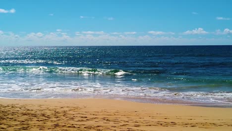 hd hawaii kauai slow motion beautiful backlit shot of ocean waves breaking on the beach in lower third, ocean in middle third, clouds at horizon and blue sky in upper third version three