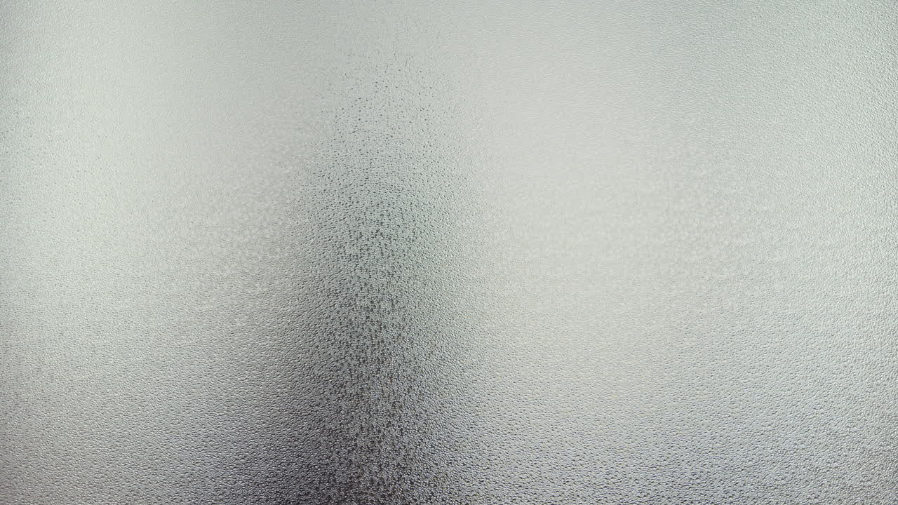 A female silhouette behind the frosted window touches the glass slowly