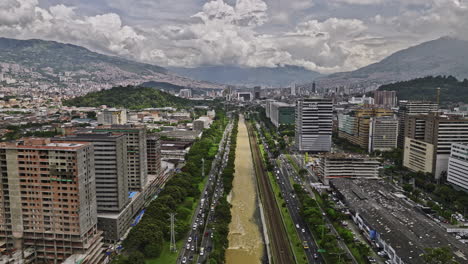 Medellin-Colombia-Aerial-v13-flyover-above-river-capturing-heavy-traffics-and-cityscape-across-Guayabal,-Villa-Carlota,-Santa-Fe-and-Alpujarra-neighborhoods---Shot-with-Mavic-3-Cine---November-2022