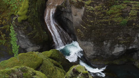 Subtle-dolly-in-looking-over-the-waterfalls-into-the-abyss-of-the-canyons-of-Fjadrargliufur-in-Iceland's-stunning-landscapes