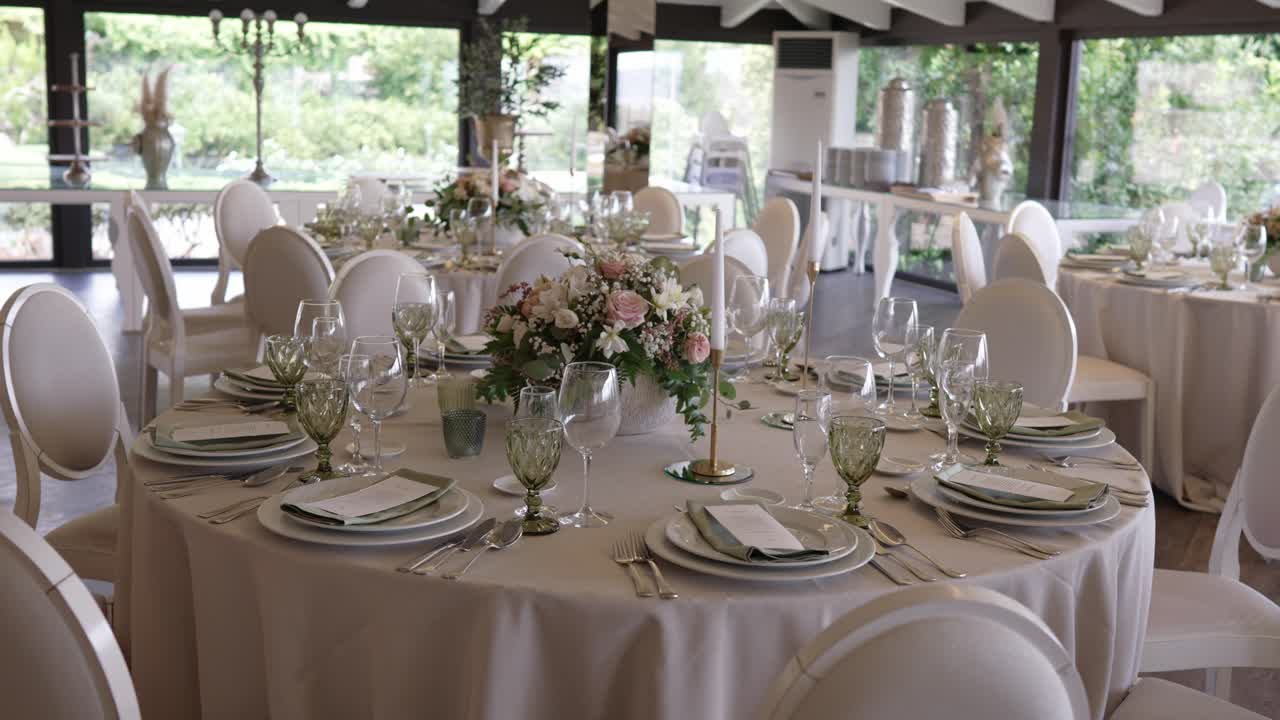 Formal wedding tables with floral centerpieces and soft daylight ambiance