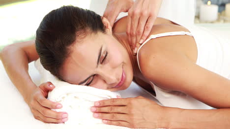 masseuse giving massage to relax woman