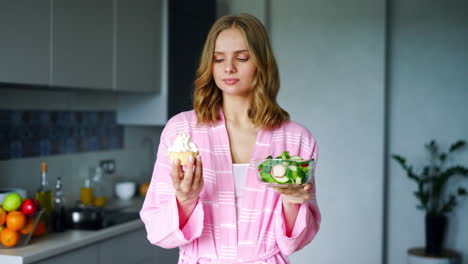 Pretty-girl-choosing-between-fresh-salad-in-bowl-or-cake.-Healthy-or-unhealthy