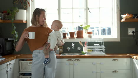 mother and baby enjoying a morning coffee in the kitchen