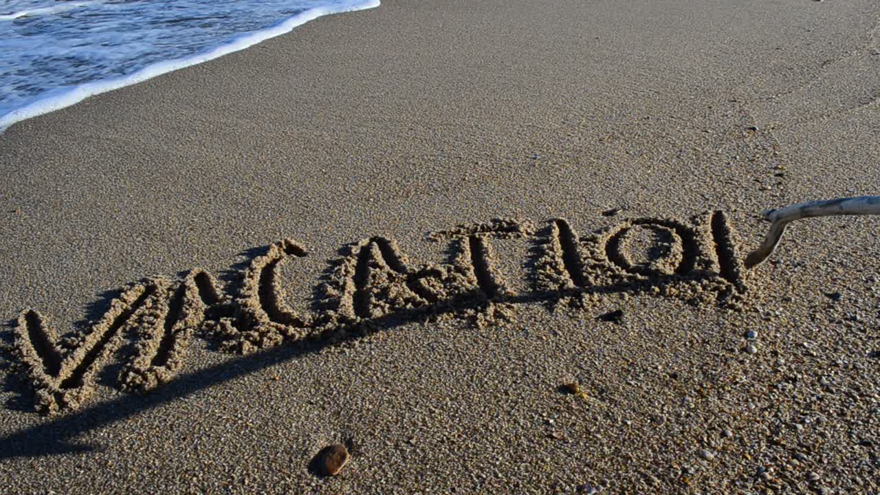 The word vacation on sand. Beach. Shooting on the beach