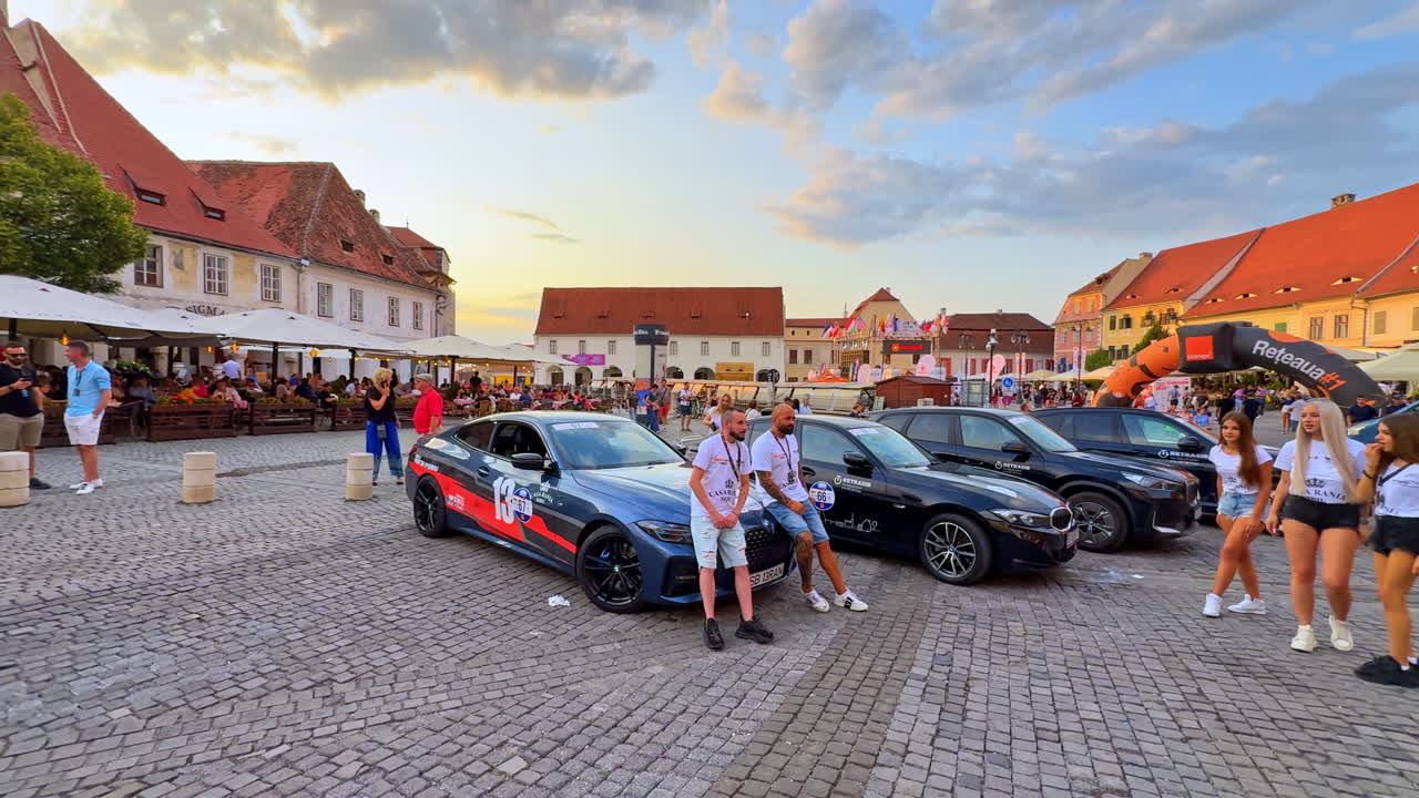 Sibiu, Romania, 1 July 2025: Car exhibition in the main square of Sibiu. Modern sports cars and people at an auto show event in Sibiu’s historic square