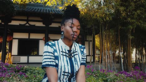woman in a garden, asian style building background