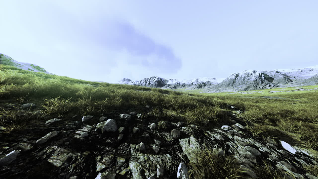 Vast mountain landscape with rocky terrain and gentle grass under a cloudy sky