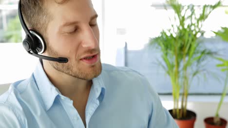 Happy-agent-working-at-his-desk-