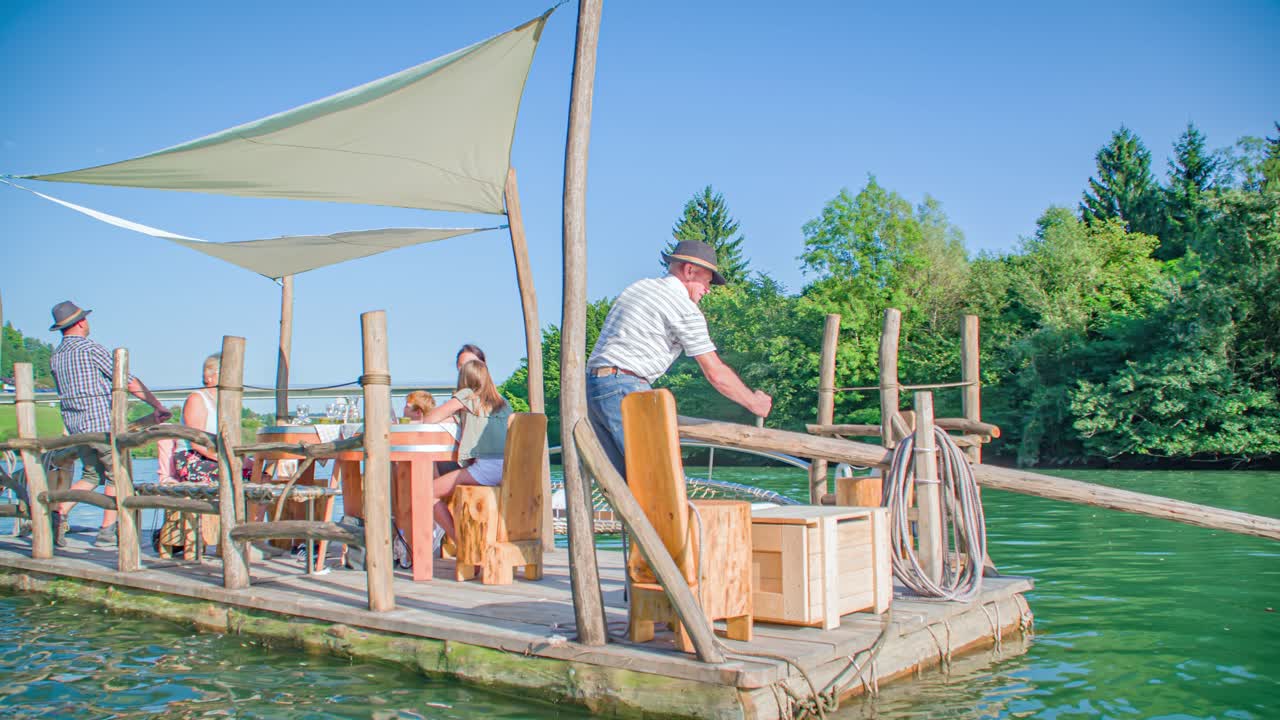Scenic Hlodovc log-raft being steered by raftsman down the Drava river, Muta, Slovenia