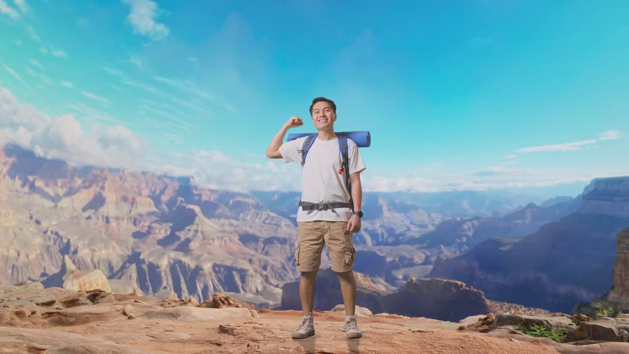Full Body Of Asian Male Hiker With Mountaineering Backpack Smiling And Flexing His Bicep While Traveling At The Top Of Mountain