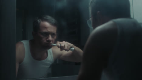 a sad man in the bathroom during his morning routine