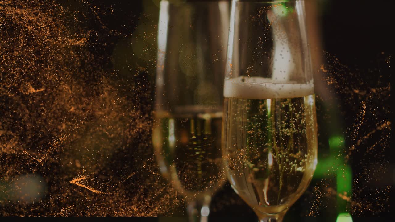 Champagne flutes being revealed as gold particles receding, bubbles rising to signal celebration