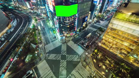 4k uhd aerial top view time lapse of green screen advertisement at ginza crosswalk intersection. crowded people walking zebra cross and car traffic long exposure.