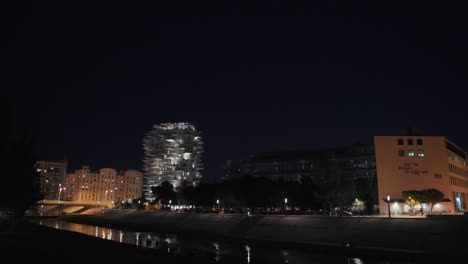 wide shot: bridges and buildings at night in montpellier, france