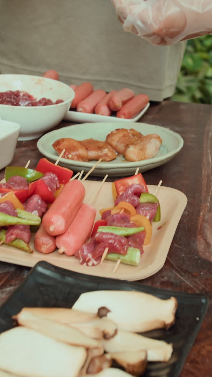 Anonymous People Skewing Meat and Vegetables at Outdoor Kitchen