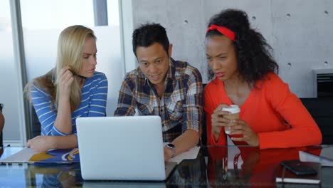 executives sitting at table and working on laptop in modern office 4k