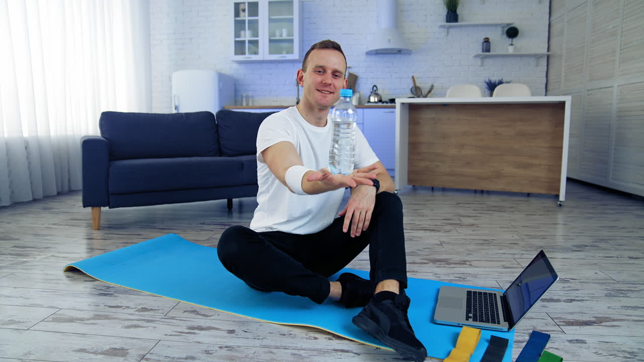 Online training at home. Young active man during workout at home