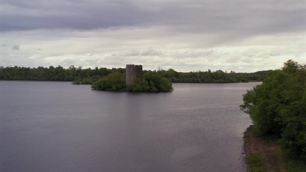Dron aéreo deslizándose lentamente de lado, encuadrando el pintoresco castillo de la isla Cloughoughter, Condado de Cavan, Irlanda.