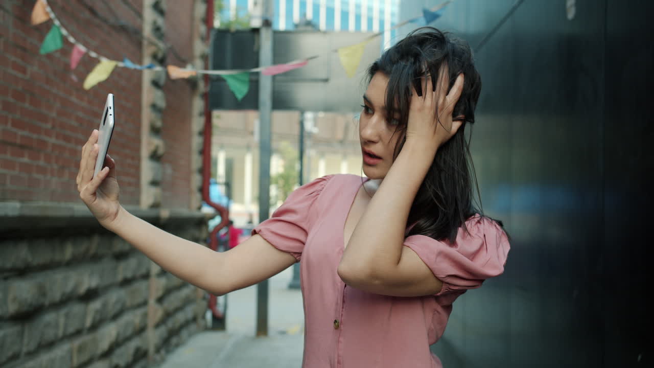 Woman Taking Selfie in Urban Alley