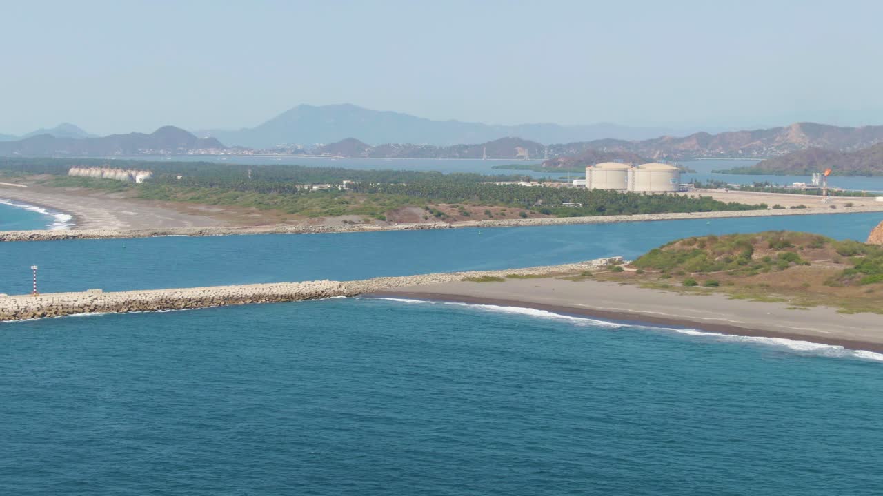 Drone shot of El Edén Beach, breakwaters, and Cuyutlán Lagoon joining the Pacific Ocean, Manzanillo, Colima