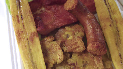 closeup-of-a-Peruvian-plate-of-patacones,-fried-ripe-plantain,-cecina-and-chorizo