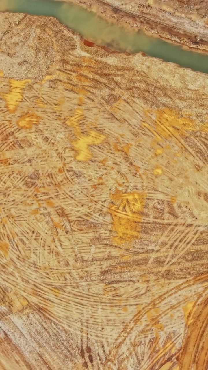 Aerial View of Construction Site with Tire Tracks and Water