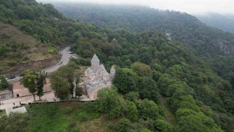 Medieval-Haghartsin-Monastery-in-Armenia-perched-on-misty-mtn-slope