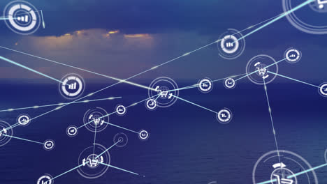 animation of network of digital icons over aerial view of sea against sunset sky