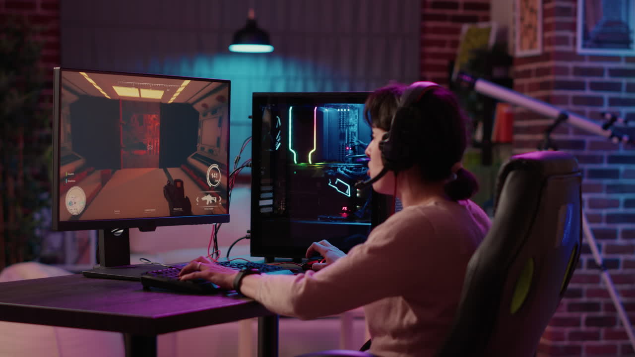 Gamer girl using pc setup playing multiplayer first person shooter talking on headset while explaining gameplay