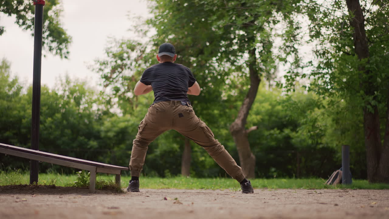 Outdoor Hip Mobility, Man Doing Wide Lunge Outdoors, Performing Lateral Hip Stretch On Park Dirt Terrain, Man Executing Broad Lateral Lunge Outside To Improve Hip Flexibility And Stability